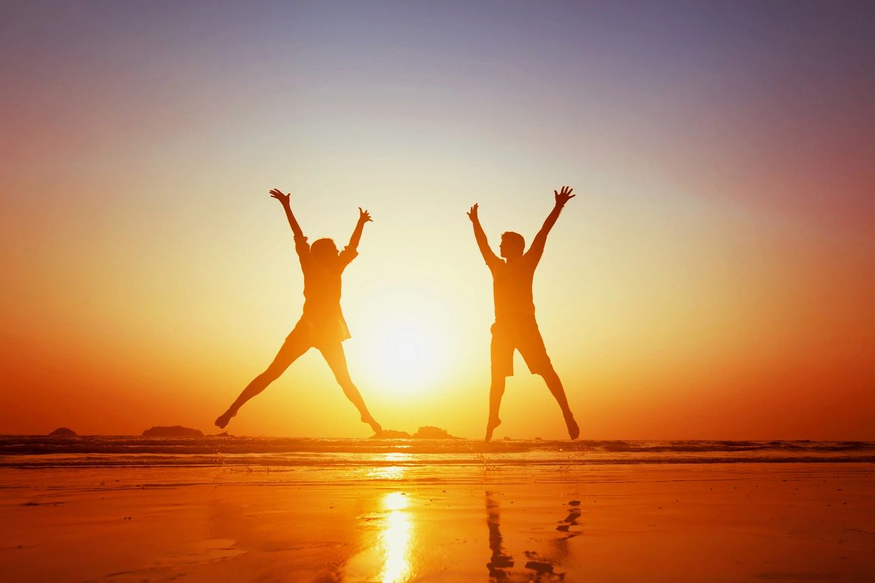 Person celebrating wellness at sunset